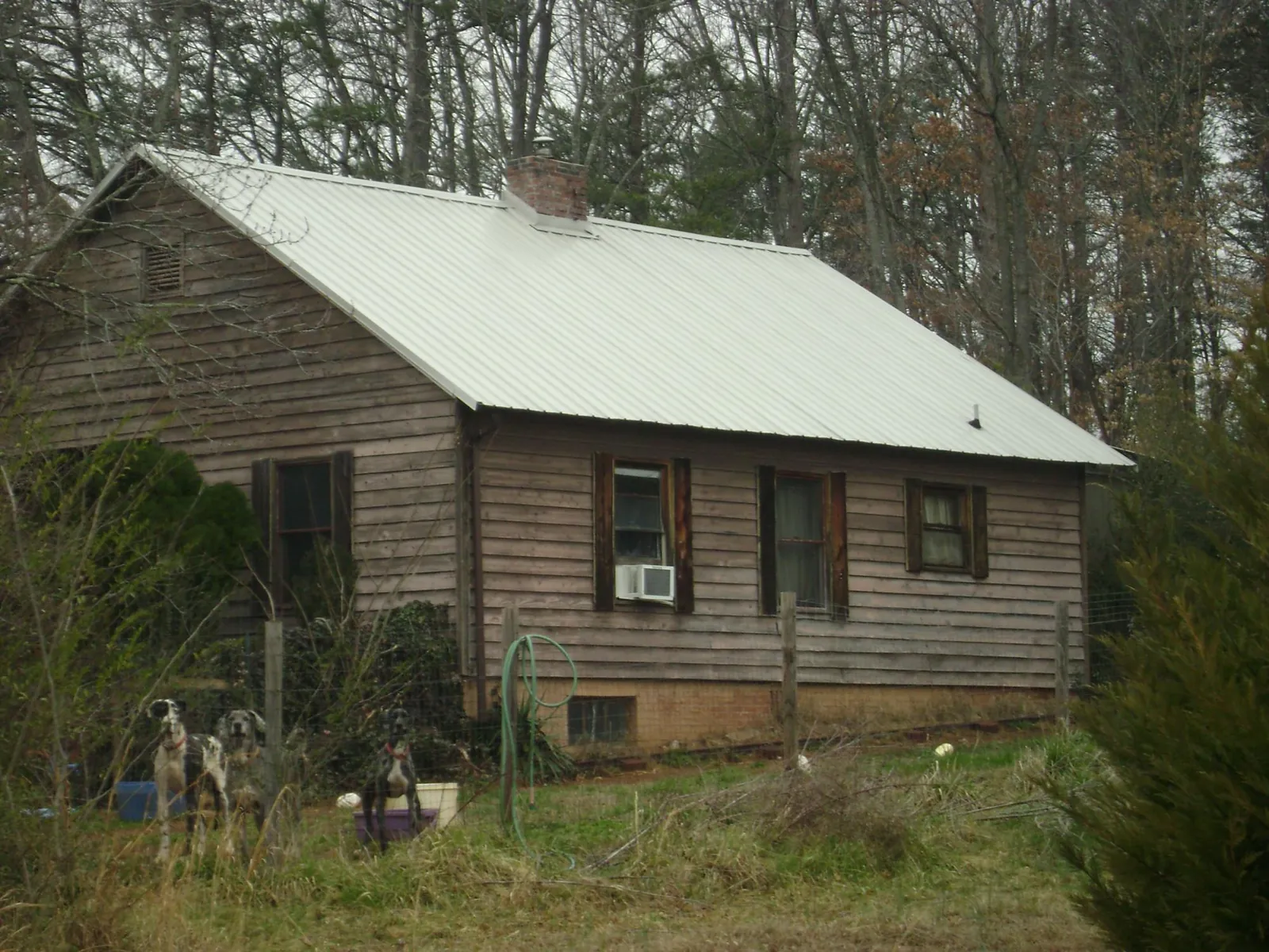 White metal roof on an old wood sided farmhouse, from a Asphalt Shingle Roof Repair job in Jefferson City